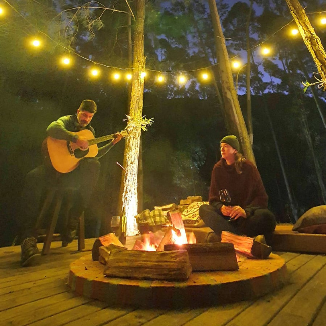 Área de fogueira do glamping Guardião da Montanha com lenha disponível